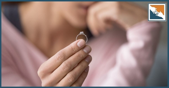 Woman holding her engagement ring